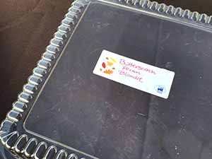 neighbors gather at for Thanksgiving Day potluck dinner