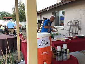neighbors gather at for Thanksgiving Day potluck dinner