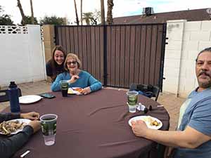 neighbors gather at for Thanksgiving Day potluck dinner