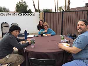 neighbors gather at for Thanksgiving Day potluck dinner