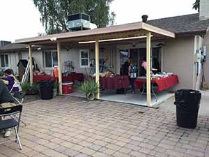 neighbors gather at for Thanksgiving Day potluck dinner