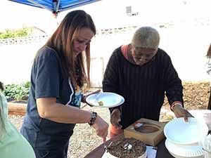 neighbors gather at for Thanksgiving Day potluck dinner