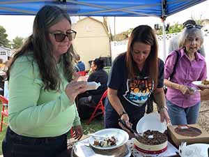 neighbors gather at for Thanksgiving Day potluck dinner