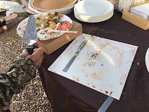 neighbors gather at for Thanksgiving Day potluck dinner