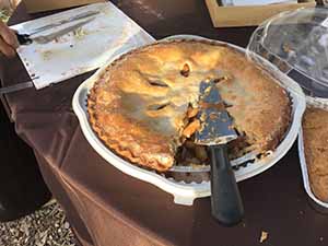 neighbors gather at for Thanksgiving Day potluck dinner