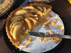 neighbors gather at for Thanksgiving Day potluck dinner