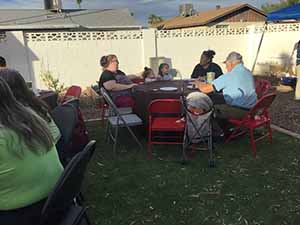 neighbors gather at for Thanksgiving Day potluck dinner