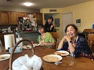 neighbors gather at for Thanksgiving Day potluck dinner