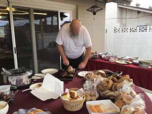 neighbors gather at for Thanksgiving Day potluck dinner