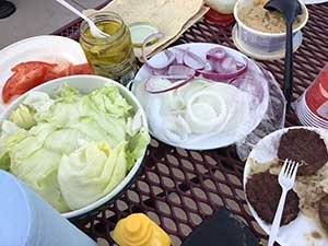 neighbors gather at park for potluck dinner birthday party
