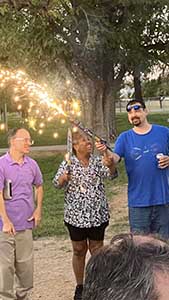 neighbors gather at park for potluck dinner birthday party