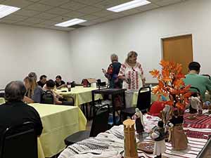 Tempe area neighbors at potluck dinner celebrating Romania